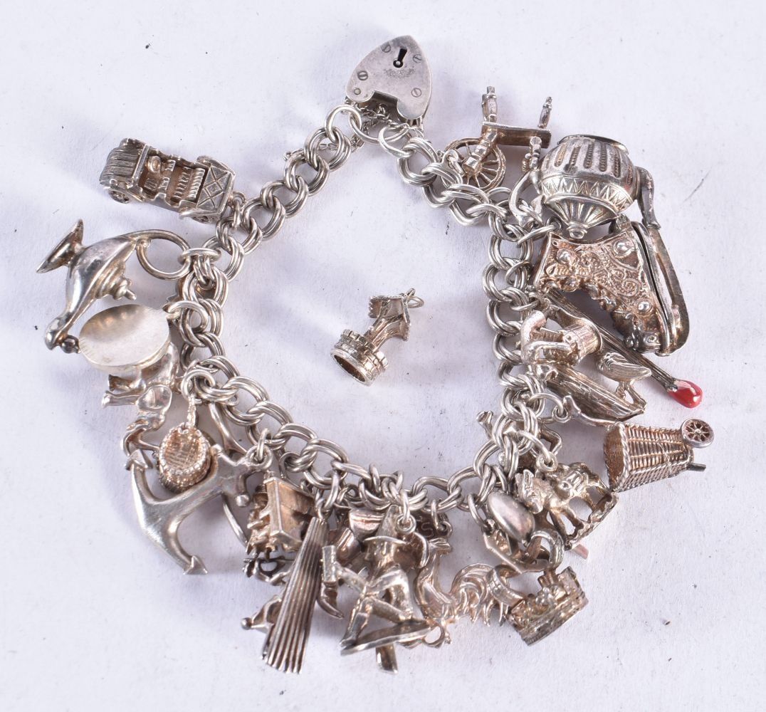 A SILVER CHARM BRACELET. 83 grams. 5cm wide. (1 of 3)