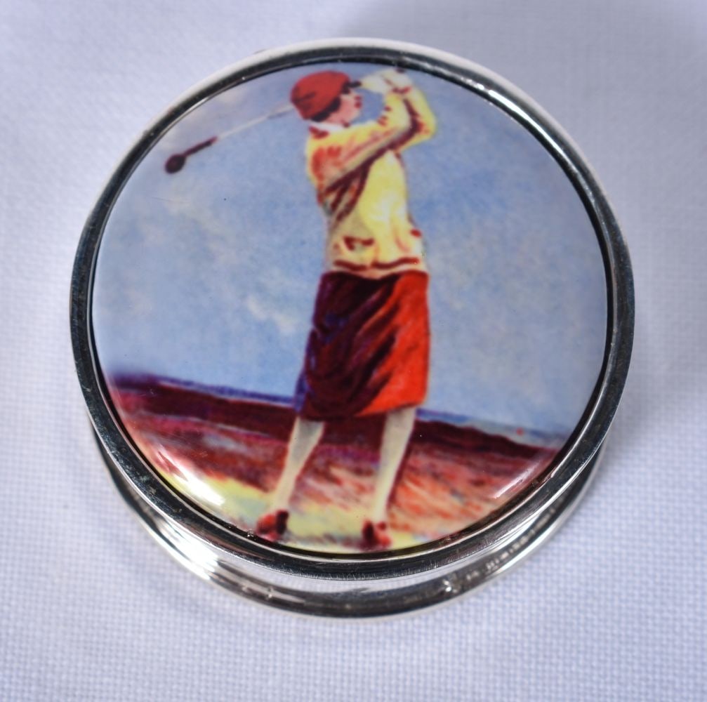A Silver and Enamel Pill Box decorated with a Lady Golfer. Stamped 925, 2.6 cm x 1.2 cm, weight 14.: A Silver and Enamel Pill Box decorated with a Lady Golfer. Stamped 925, 2.6 cm x 1.2 cm, weight 14.3g