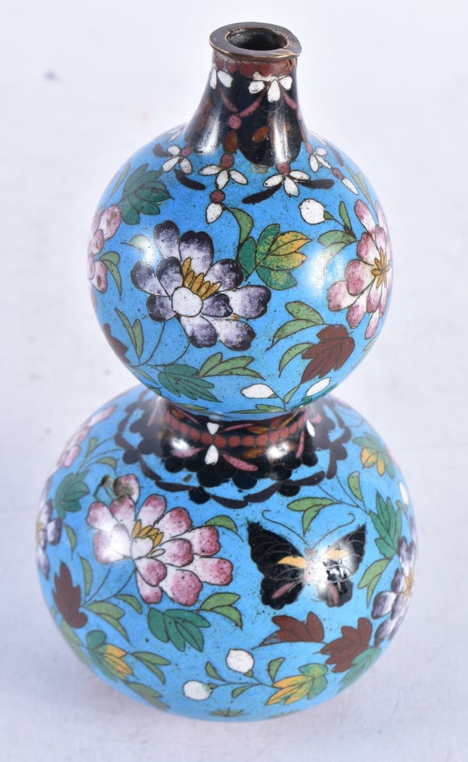 A LATE 19TH CENTURY JAPANESE MEIJI PERIOD CLOISONNE ENAMEL GOURD VASE decorated with flowers and but: A LATE 19TH CENTURY JAPANESE MEIJI PERIOD CLOISONNE ENAMEL GOURD VASE decorated with flowers and butterflies. 16.5cm high.