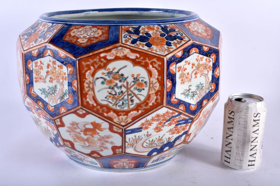 A LARGE 19TH CENTURY JAPANESE MEIJI PERIOD IMARI JARDINIERE painted with landscapes and fish. 34 cm: A LARGE 19TH CENTURY JAPANESE MEIJI PERIOD IMARI JARDINIERE painted with landscapes and fish. 34 cm x 26 cm.