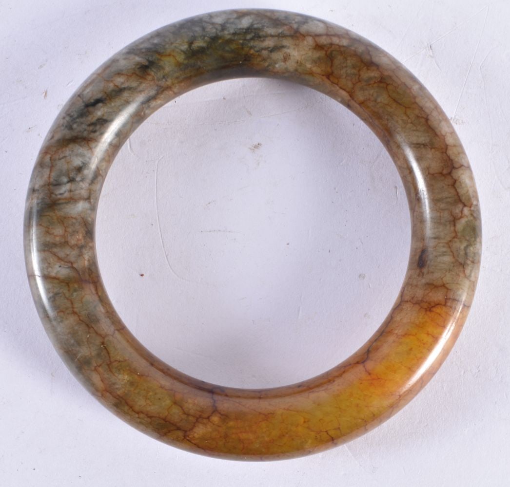A CHINESE QING DYNASTY JADE BANGLE. 119 grams. 7 cm diameter. (1 of 3)