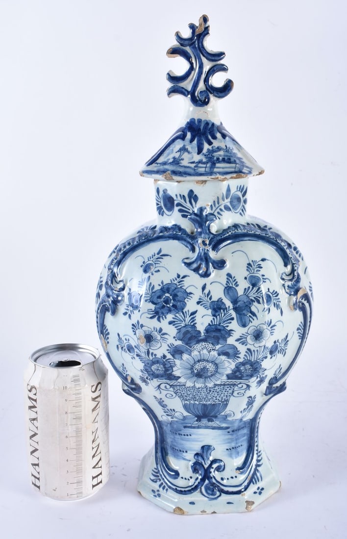 AN 18TH CENTURY DUTCH DELFT BLUE AND WHITE POTTERY VASE AND COVER painted with vases of flowers. 36 (1 of 6)