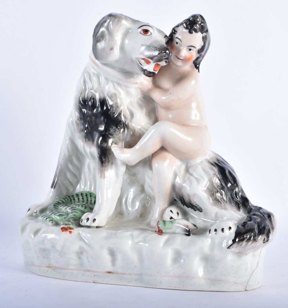 A 19TH CENTURY STAFFORDSHIRE POTTERY FIGURE OF A NUDE BOY modelled riding upon a large dog. 18 cm x: A 19TH CENTURY STAFFORDSHIRE POTTERY FIGURE OF A NUDE BOY modelled riding upon a large dog. 18 cm x 15 cm.