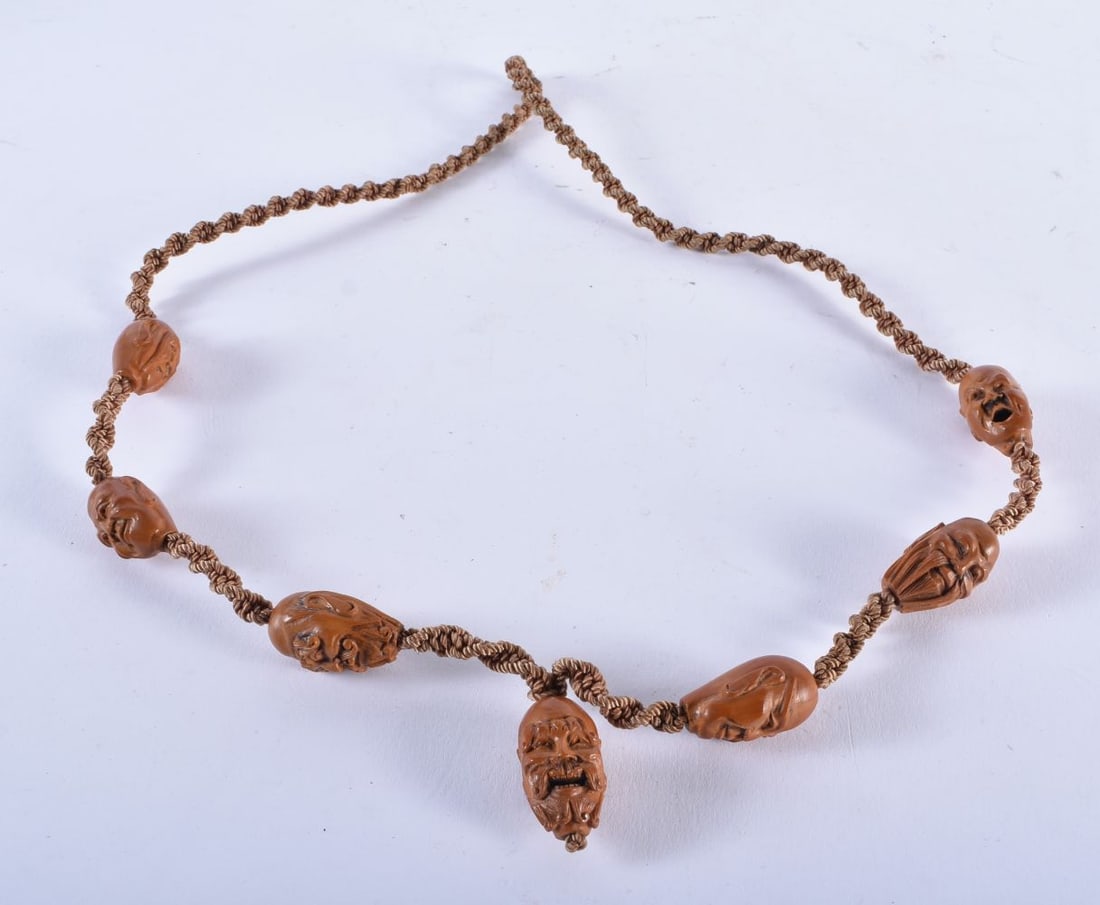 A 19TH CENTURY CHINESE CARVED NUT MASK NECKLACE Qing. 27.8 grams. 79 cm long. (1 of 3)