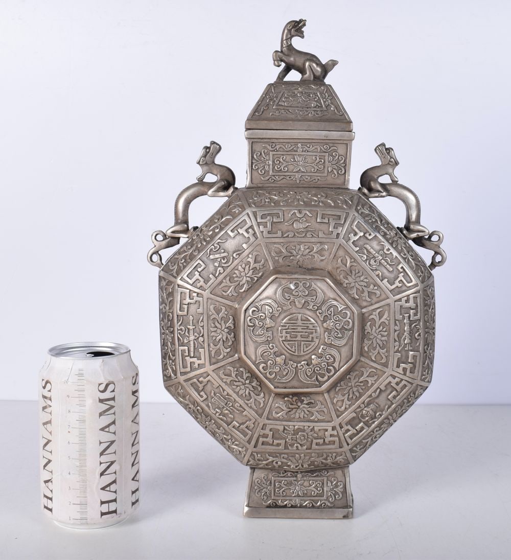 A Chinese white metal embossed Moon Flask decorated with twin beast handles and a floral pattern 34: A Chinese white metal embossed Moon Flask decorated with twin beast handles and a floral pattern 34cm.