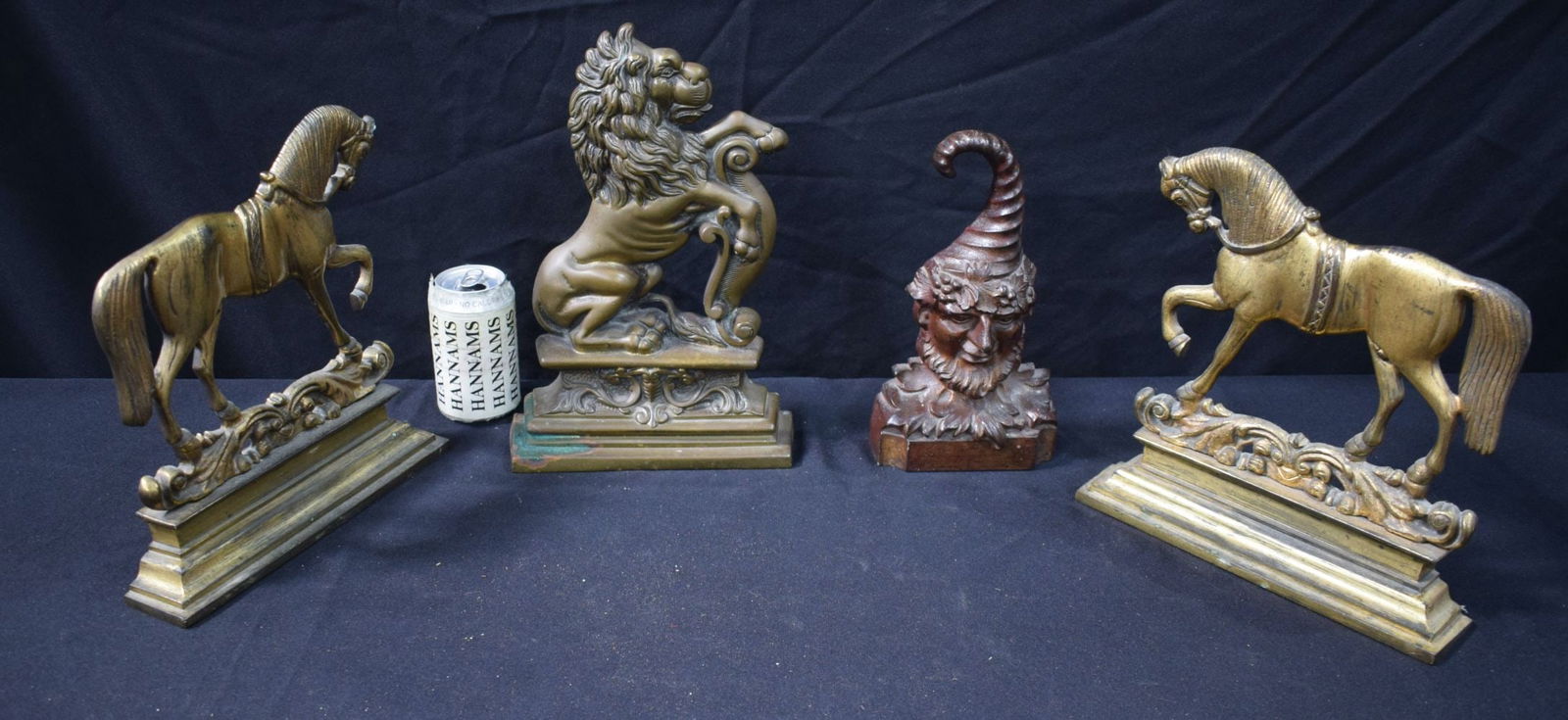 A Vintage jester door stop, together with a lion doorstops and two fireguard ends. Largest 32 cm. (4: A Vintage jester door stop, together with a lion doorstops and two fireguard ends. Largest 32 cm. (4)