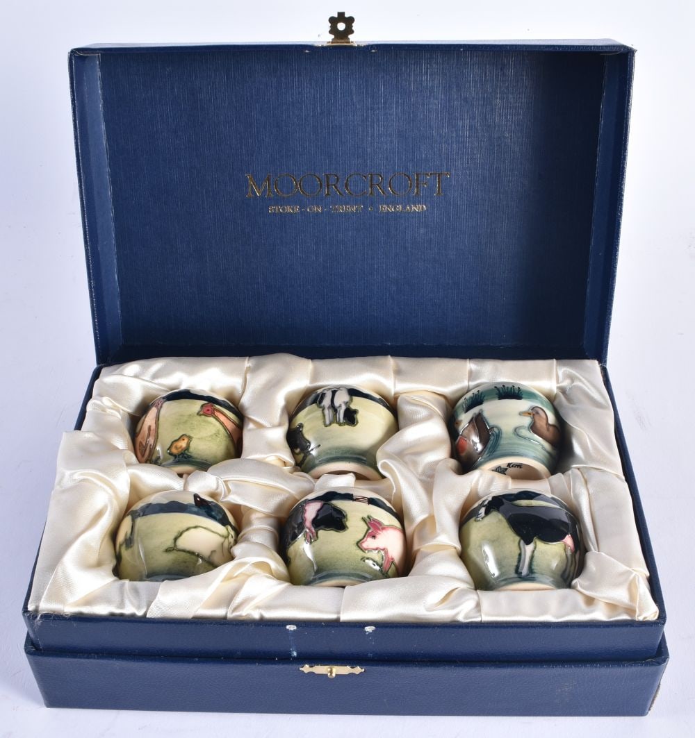 AN UNUSUAL SET OF MOORCROFT EGG CUPS. Each cup 5.5 cm high. (6): AN UNUSUAL SET OF MOORCROFT EGG CUPS. Each cup 5.5 cm high. (6)