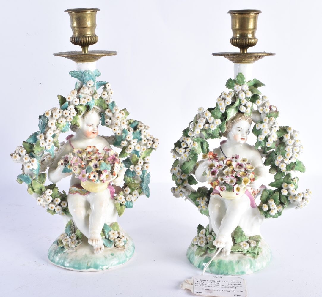 A RARE PAIR OF 18TH CENTURY DERBY PORCELAIN CANDLESTICKS formed as figures holding baskets of flower (1 of 8)
