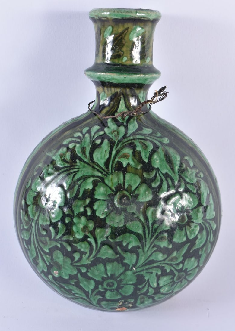 AN UNUSUAL 19TH CENTURY MIDDLE EASTERN INDIAN POTTERY FLASK Mughal type, painted with green flowers.: AN UNUSUAL 19TH CENTURY MIDDLE EASTERN INDIAN POTTERY FLASK Mughal type, painted with green flowers. 21 cm x 13 cm.