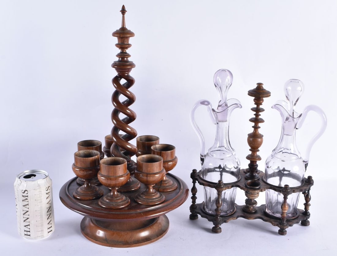 AN ANTIQUE TREEN EGG CUP HOLDER together with a treen carved wood liquor set. Largest 40 cm high. (2: AN ANTIQUE TREEN EGG CUP HOLDER together with a treen carved wood liquor set. Largest 40 cm high. (2)