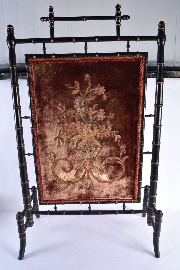 AN AESTHETIC MOVEMENT EBONISED CARVED WOOD FIRE SCREEN inset with an embroidered panel of flowers. 1 (1 of 5)