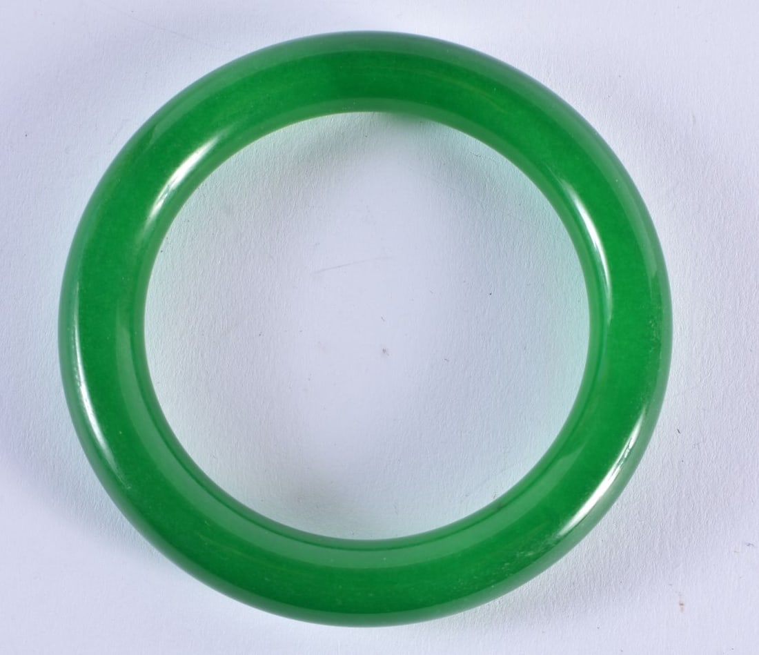 A CHINESE SPINACH JADE BANGLE. 69.5 grams. Internal diameter 6.25 cm. (1 of 3)