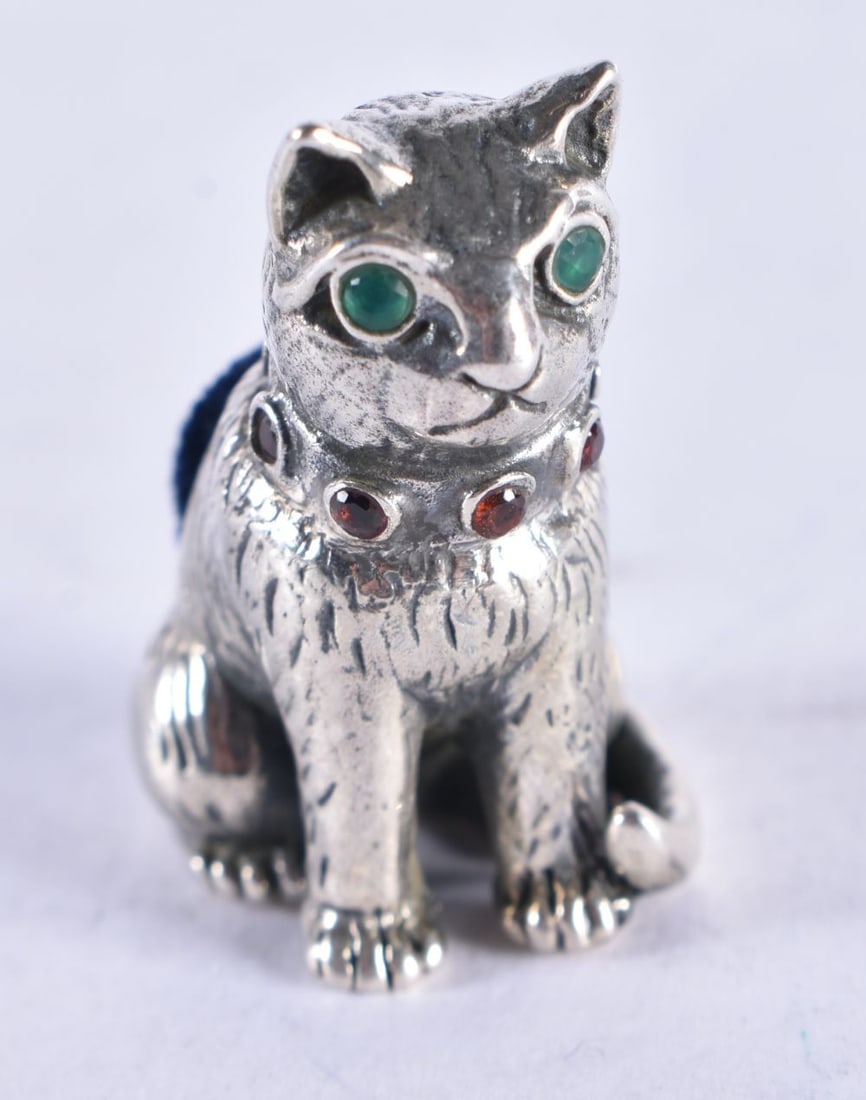 A SILVER CAT PIN CUSHION. 13.3 grams. 2.5 cm x 2 cm. (1 of 3)