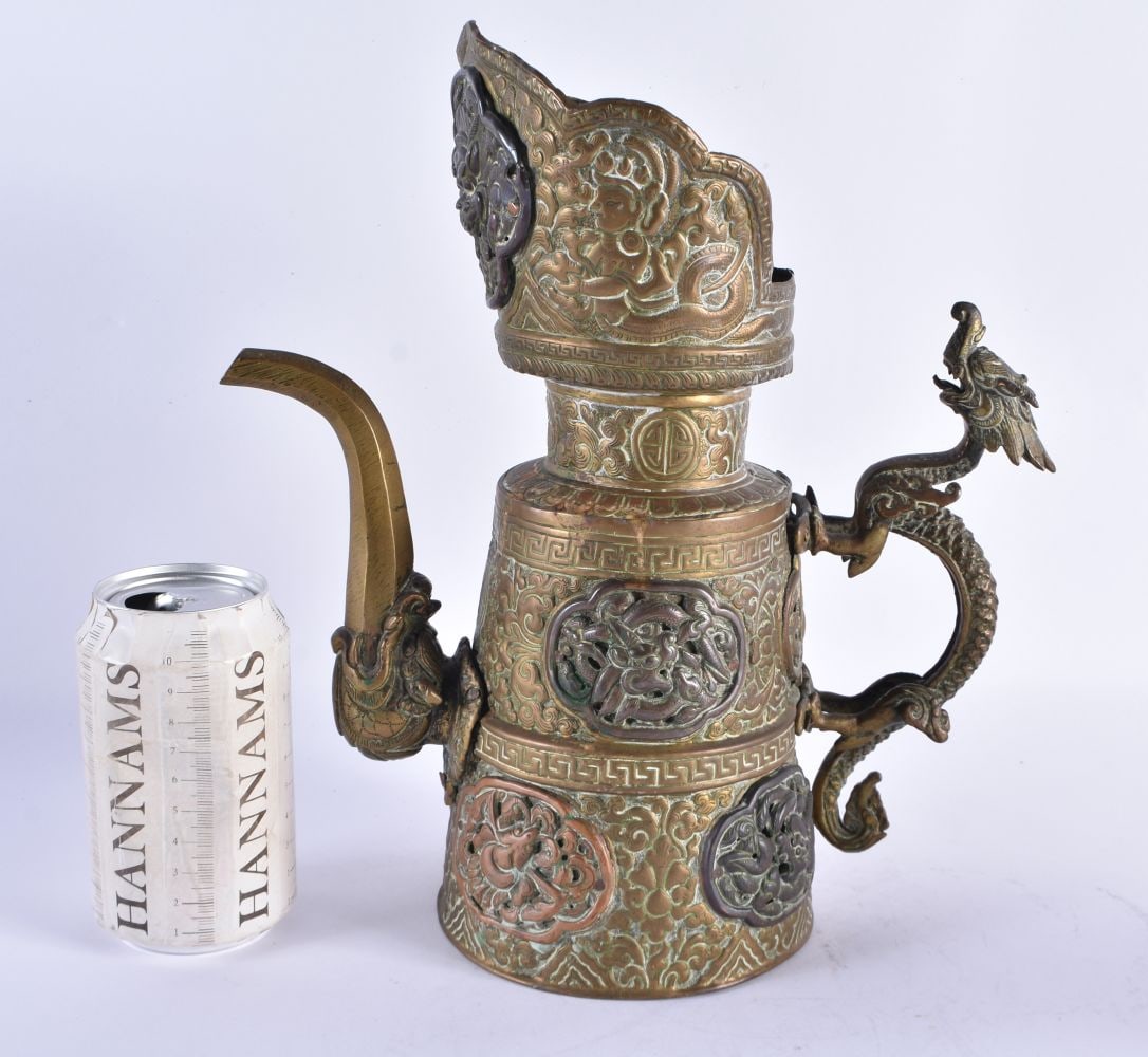 A LARGE 18TH/19TH CENTURY TIBETAN MIXED METAL REPOUSSE EWER decorated with beasts and dragons. 30 cm: A LARGE 18TH/19TH CENTURY TIBETAN MIXED METAL REPOUSSE EWER decorated with beasts and dragons. 30 cm high.