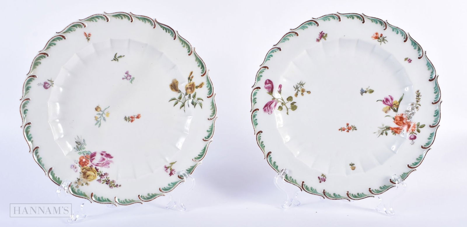 18th century Chelsea pair of moulded plates painted with flower under a feather edge border. 21cm di: 18th century Chelsea pair of moulded plates painted with flower under a feather edge border. 21cm diameter (pr)