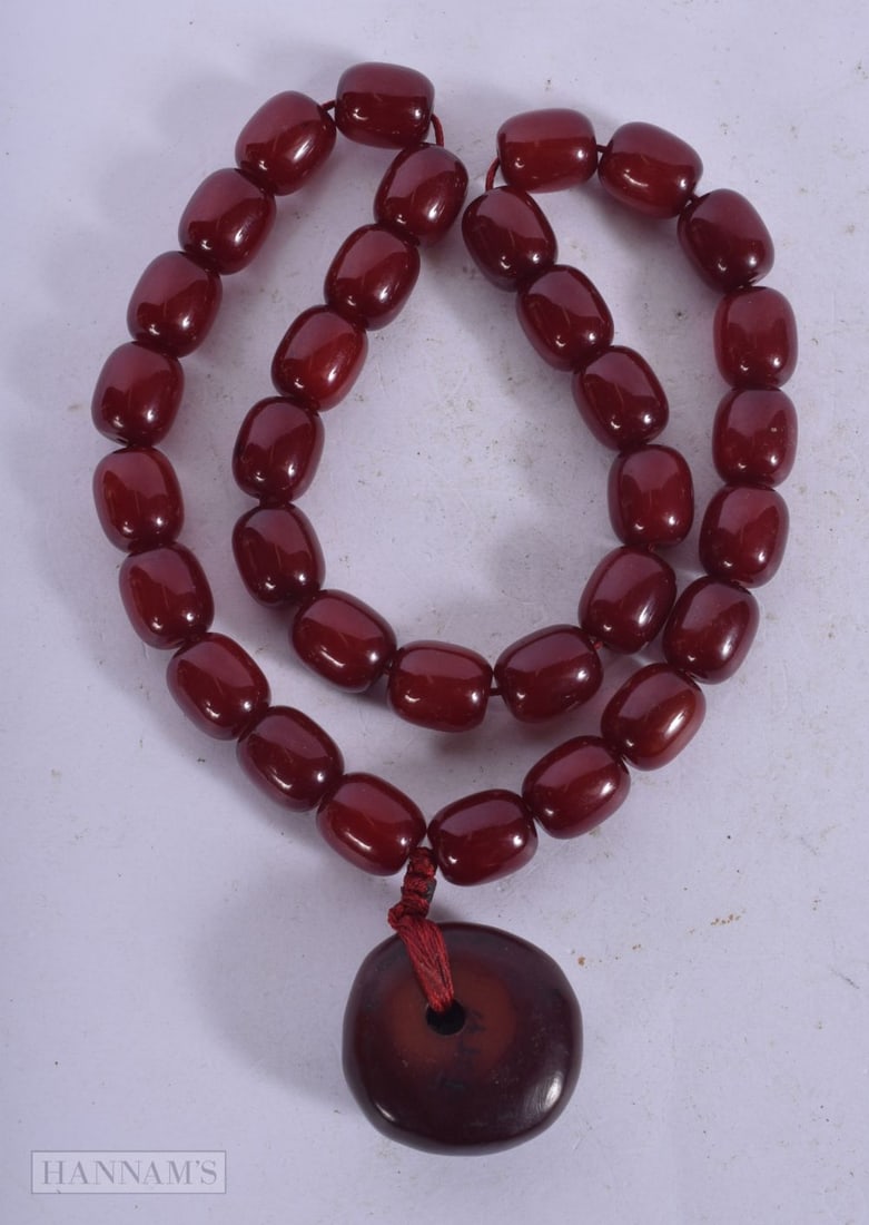 A CHERRY AMBER TYPE NECKLACE. 62 grams. 48 cm long. (1 of 3)