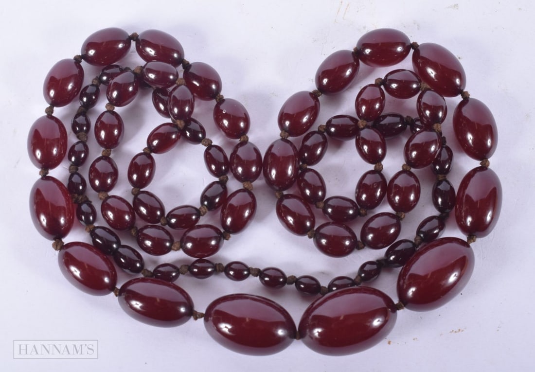 A CHERRY AMBER TYPE NECKLACE. 71 grams. 108 cm long. (1 of 3)