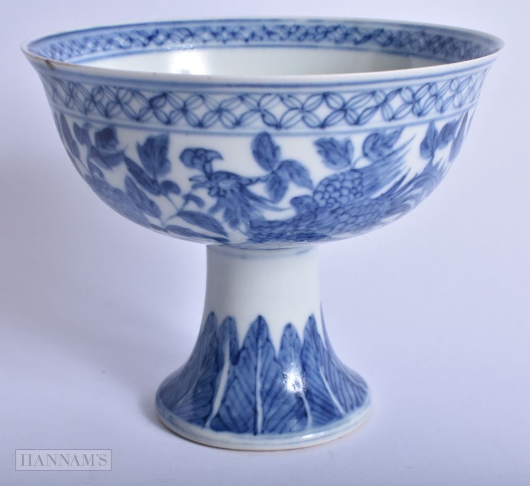 A CHINESE QING DYNASTY BLUE AND WHITE PORCELAIN STEM CUP painted with phoenix birds. 13.75 cm wide.: A CHINESE QING DYNASTY BLUE AND WHITE PORCELAIN STEM CUP painted with phoenix birds. 13.75 cm wide.