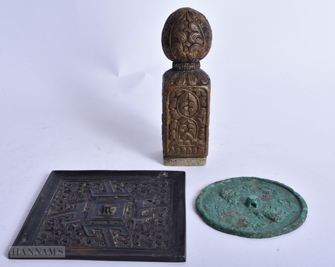 A 19TH CENTURY TIBETAN BRONZE SEAL together with two Chinese mirrors. Largest 11 cm square. (3) (1 of 6)