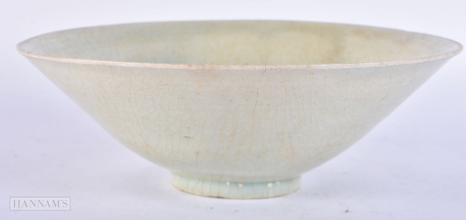 A CHINESE SUNG DYNASTY CONICAL FORM BOWL incised with fish and trailing water. 18.5 cm diameter.: A CHINESE SUNG DYNASTY CONICAL FORM BOWL incised with fish and trailing water. 18.5 cm diameter.
