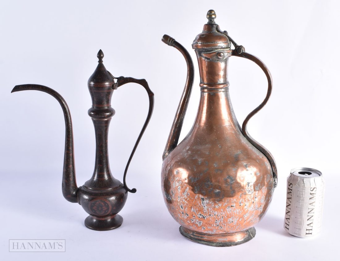 A LARGE EARLY ISLAMIC PERSIAN COPPER ALLOY EWER together with an enamelled Indian ewer. Largest 40 c (1 of 6)