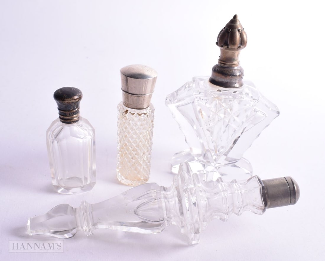 FOUR ANTIQUE SILVER MOUNTED SCENT BOTTLE. 382 grams overall. Largest 11.25cm high. (4) (1 of 3)