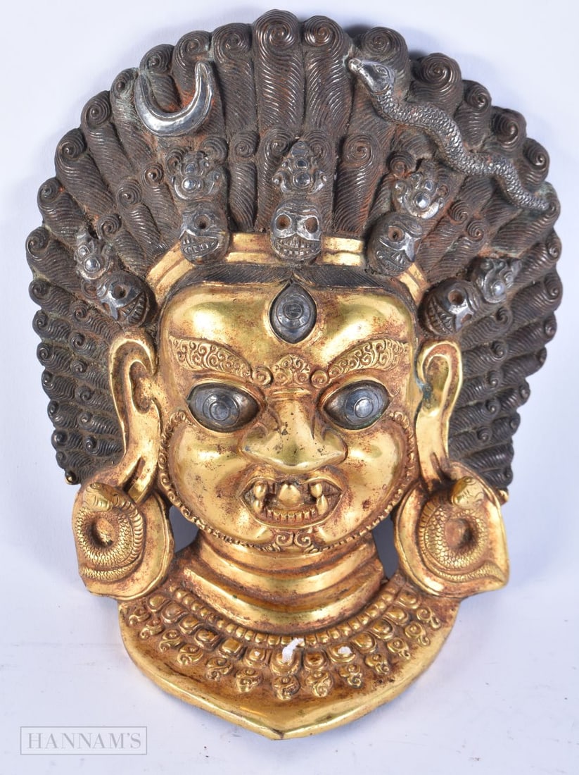 A 19TH CENTURY TIBETAN SILVER OVERLAID GILT BRONZE BUDDHA MASK HEAD. 20 cm x 14 cm. (1 of 5)