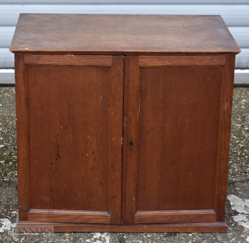 A vintage five drawer Gentleman's cabinet with front opening doors. Label to reverse, John Taylor an: A vintage five drawer Gentleman's cabinet with front opening doors. Label to reverse, John Taylor and Son, Edinburgh 58.5 x 66 x 43cm