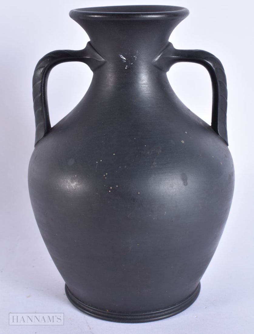 A WEDGWOOD BLACK BASALT TWIN HANDLED PORTLAND VASE. 15 cm high.: A WEDGWOOD BLACK BASALT TWIN HANDLED PORTLAND VASE. 15 cm high.