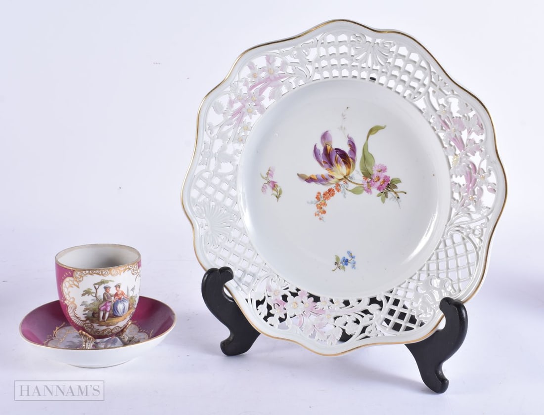 A 19TH CENTURY GERMAN MEISSEN PORCELAIN CUP AND SAUCER together with a reticulated Meissen plate. La: A 19TH CENTURY GERMAN MEISSEN PORCELAIN CUP AND SAUCER together with a reticulated Meissen plate. Largest 21 cm wide. (3)