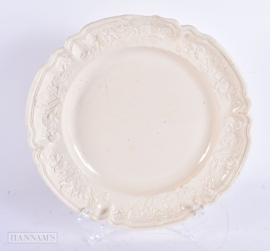 AN 18TH CENTURY EUROPEAN SALT GLAZED MOULDED PLATE decorated with flowers and vines. 23 cm wide. (1 of 3)