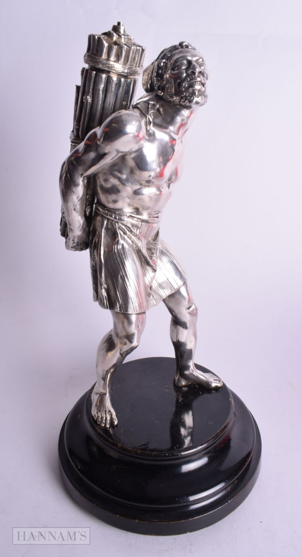 AN EXTREMELY RARE VICTORIAN SILVER TABLE LIGHTER by James Barclay Hennell, formed as a male carrying: AN EXTREMELY RARE VICTORIAN SILVER TABLE LIGHTER by James Barclay Hennell, formed as a male carrying logs upon his back. 1790 grams overall. 33 cm high.