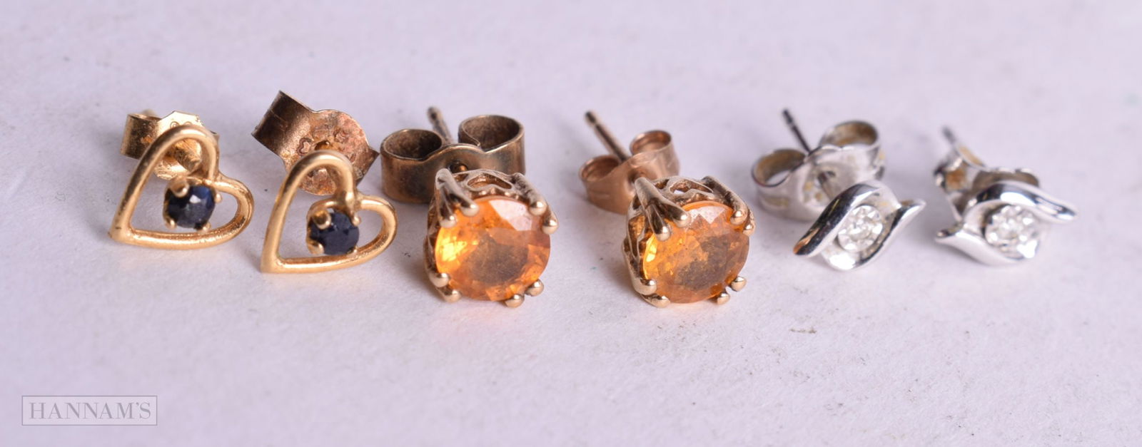 3 x 9ct gold stone set stud earrings including diamond and sapphire (2.1g). (6) (1 of 2)