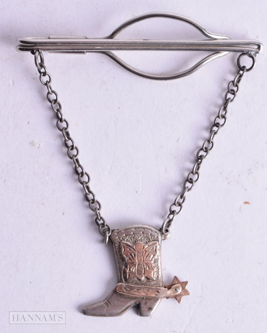 A SILVER COWBOY BOOT WITH SPUR TIE CLIP. Stamped Sterling, 8.1cm x 6.2cm, weight 12g: A SILVER COWBOY BOOT WITH SPUR TIE CLIP. Stamped Sterling, 8.1cm x 6.2cm, weight 12g