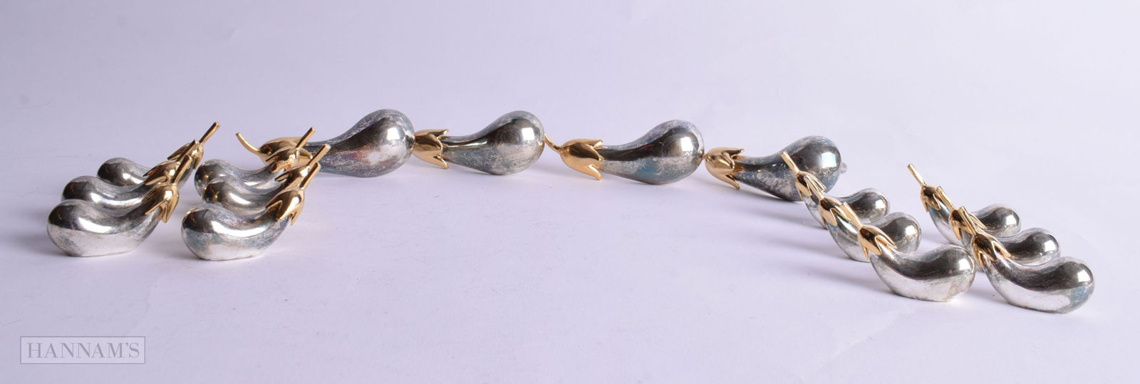 FOUR SILVER PLATED NAPKIN RINGS WITH 12 MATCHING KNIFE RESTS IN THE FORM OF AUBERGINES. Rings 7.3cm (1 of 4)