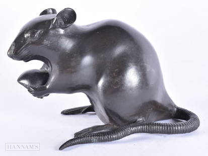 A LATE 19TH CENTURY JAPANESE MEIJI PERIOD BRONZE OKIMONO modelled as a rat clutching a nut. 15 cm wi: A LATE 19TH CENTURY JAPANESE MEIJI PERIOD BRONZE OKIMONO modelled as a rat clutching a nut. 15 cm wide.