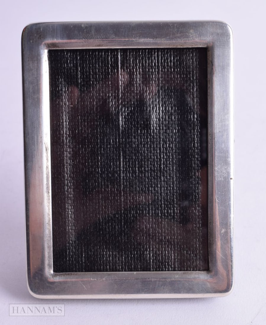 A TIFFANY & CO SILVER PHOTO FRAME.  Stamped Tiffany & Co Sterling, 9.6cm x 7.3cm x 1.3cm (external), (1 of 3)