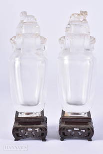 A FINE PAIR OF 18TH/19TH CENTURY CHINESE CARVED ROCK CRYSTAL VASES AND COVERS Qianlong/Jiaqing, with: A FINE PAIR OF 18TH/19TH CENTURY CHINESE CARVED ROCK CRYSTAL VASES AND COVERS Qianlong/Jiaqing, with silver inlaid Zitan bases. Bottle 12.5 cm high.