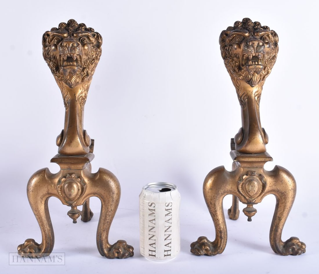 A PAIR OF 19TH CENTURY ENGLISH COUNTRY HOUSE BRONZE FIRE DOGS formed as scowling lions. 34 cm x 22 c (1 of 4)