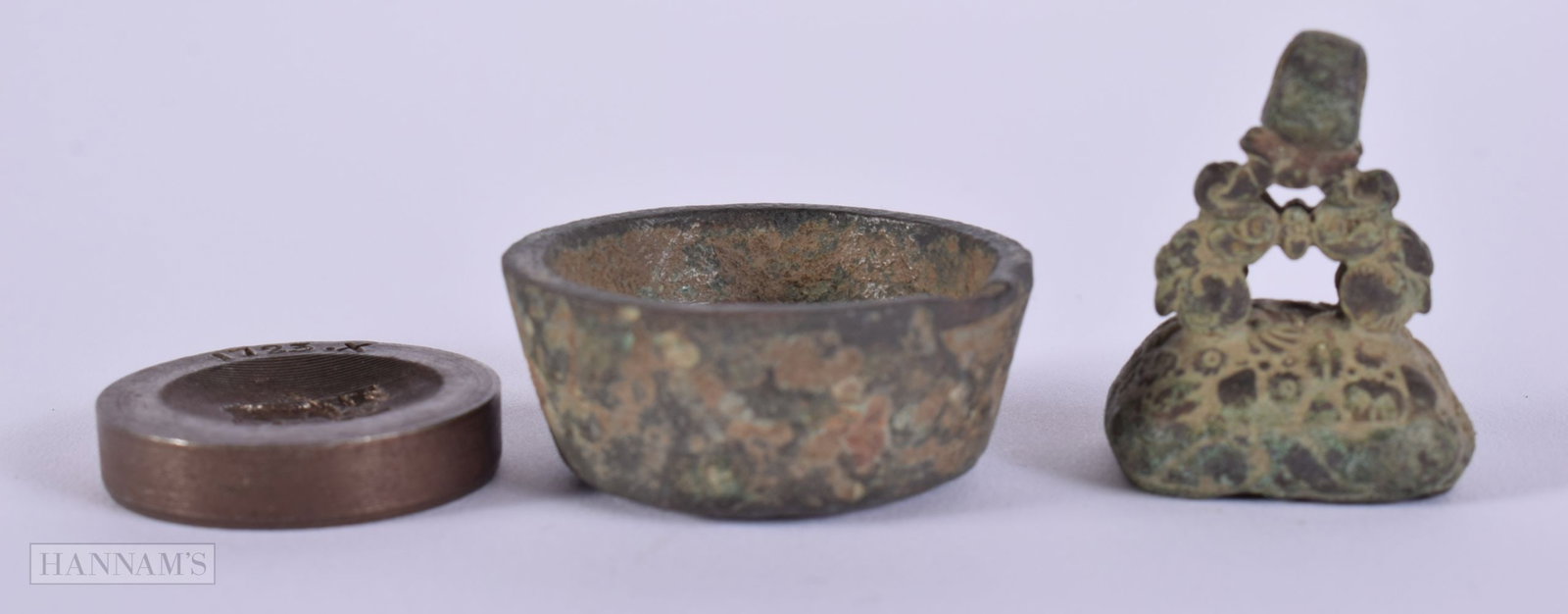 A VERY EARLY BRONZE PENDANT SEAL together with a medieval pot & a weight dated 1723. (3): A VERY EARLY BRONZE PENDANT SEAL together with a medieval pot & a weight dated 1723. (3)