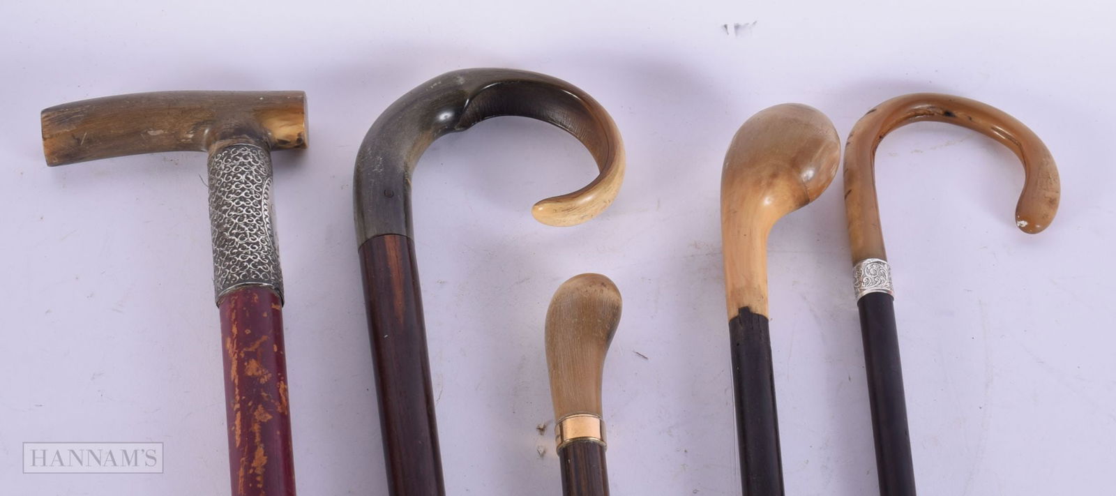 THREE ANTIQUE CARVED RHINOCEROS HORN CANES together with two others. 90 cm long. (5) (1 of 3)