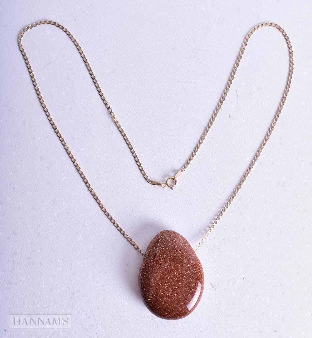 A 9CT GOLD GOLDSTONE NECKLACE. 18.7 grams. Chain 42 cm long, pendant 3.75 cm x 2.75 cm. (1 of 2)