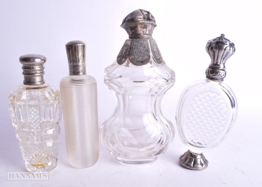 FOUR ANTIQUE SILVER MOUNTED SCENT BOTTLES. 277 grams. Largest 11.25 cm high. (4) (1 of 5)