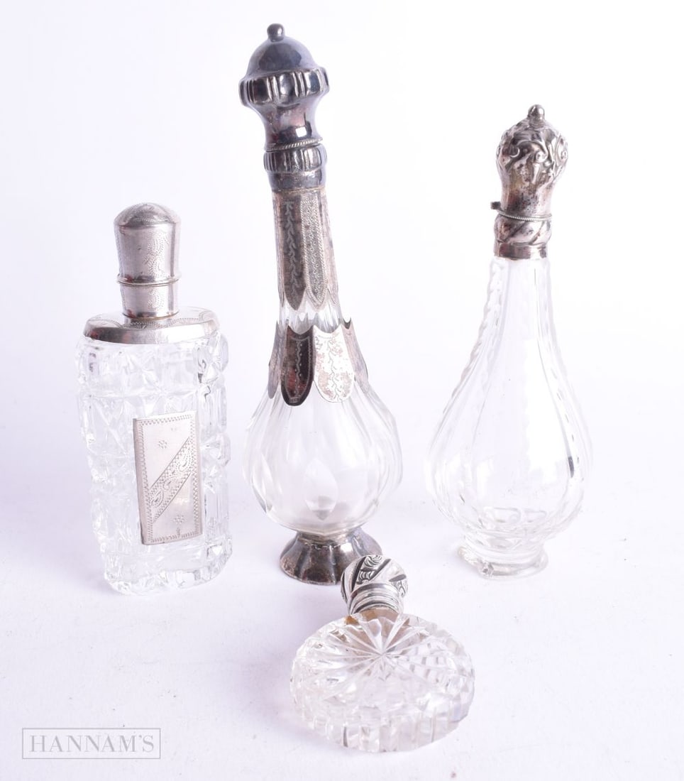 FOUR ANTIQUE SILVER MOUNTED SCENT BOTTLES. 175 grams. Largest 12.25 cm high. (4) (1 of 4)