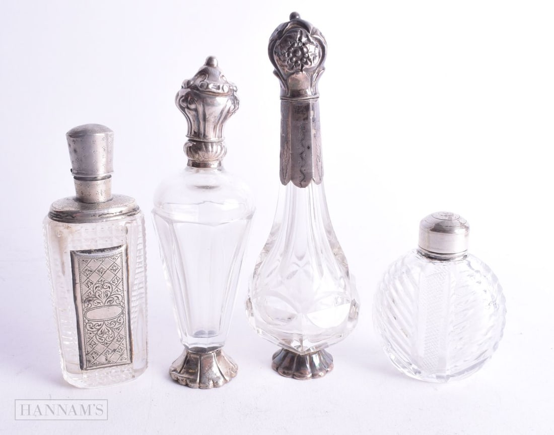 FOUR ANTIQUE SILVER MOUNTED SCENT BOTTLES. 247 grams. Largest 12.5 cm high. (4) (1 of 4)