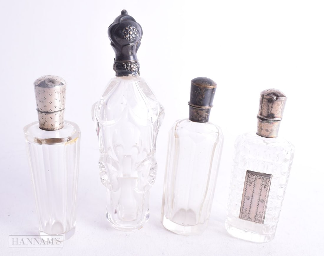 FOUR ANTIQUE SILVER AND GLASS SCENT BOTTLES. 239 grams. Largest 12.5 cm high. (4) (1 of 4)