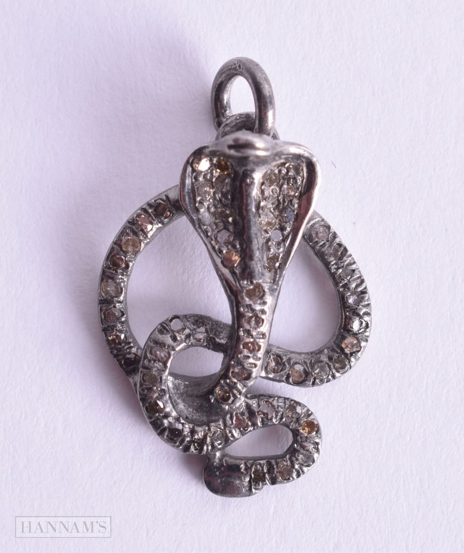 A DIAMOND SNAKE CHARM. 1.7 grams. 2 cm x 1.5 cm.: A DIAMOND SNAKE CHARM. 1.7 grams. 2 cm x 1.5 cm.