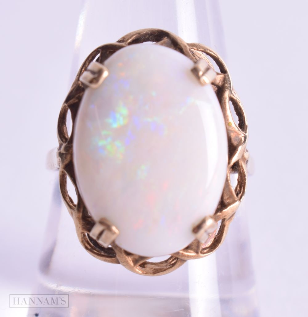 A 9CT GOLD AND OPAL RING. P. 4.4 grams. (1 of 3)