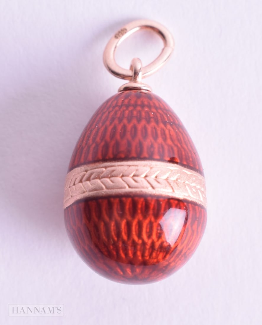 A SILVER GILT ENAMEL EGG CHARM. 2.9 grams. 2.75 cm x 1.25 cm. (1 of 2)