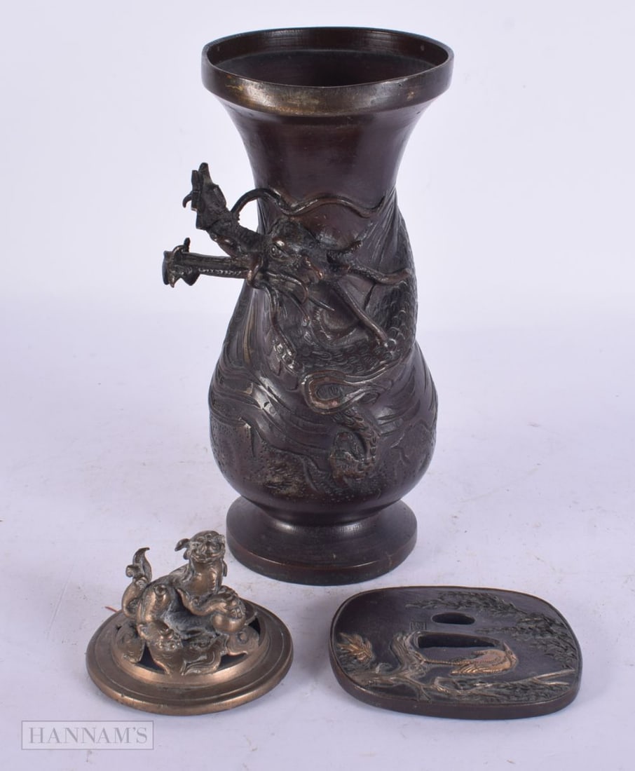 A 19TH CENTURY JAPANESE MEIJI PERIOD BRONZE VASE together with a bronze lid & a bronze tsuba. Larges: A 19TH CENTURY JAPANESE MEIJI PERIOD BRONZE VASE together with a bronze lid & a bronze tsuba. Largest 17 cm high. (3)